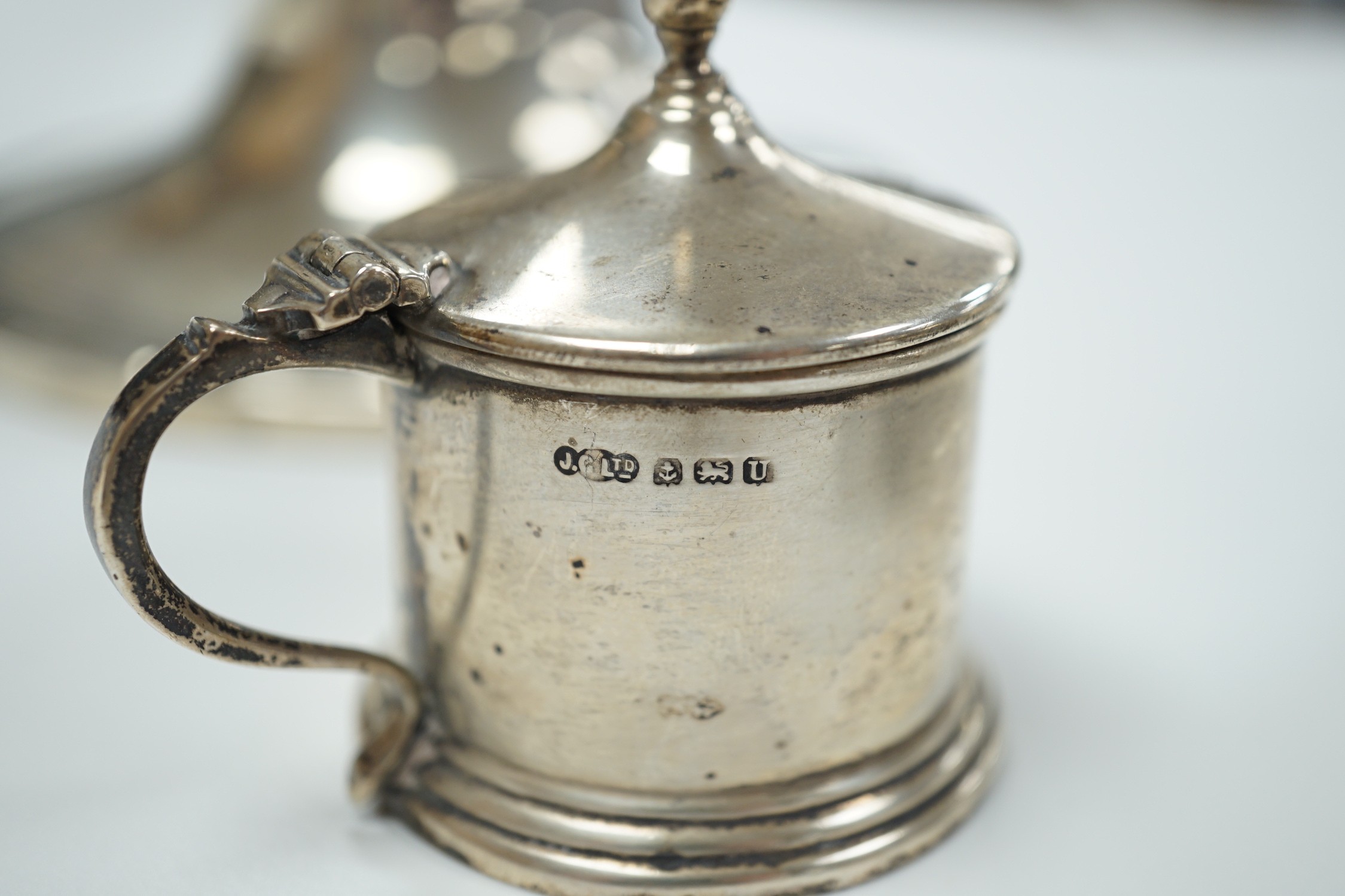 A George V silver octagonal sugar caster, Sheffield, 1910, 15.9cm, a George V silver mounted capstan inkwell and a small silver mustard pot.